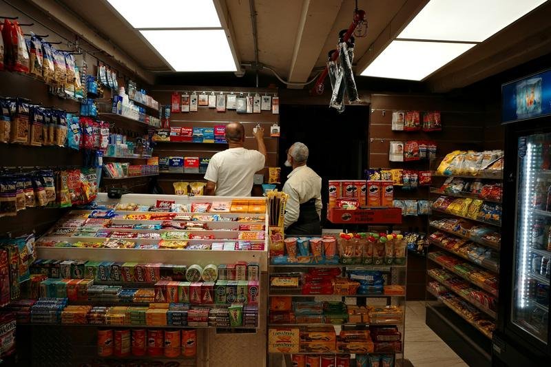 A cashier counter in a busy convenience store at night