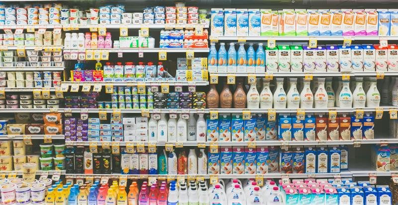 Rows of bottled drinks on store shelves