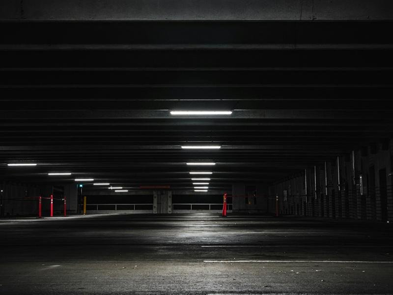 An empty multi-storey parking garage lit at night