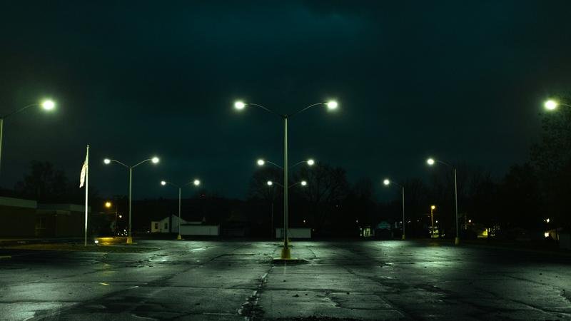 A parking lot under street lights at night